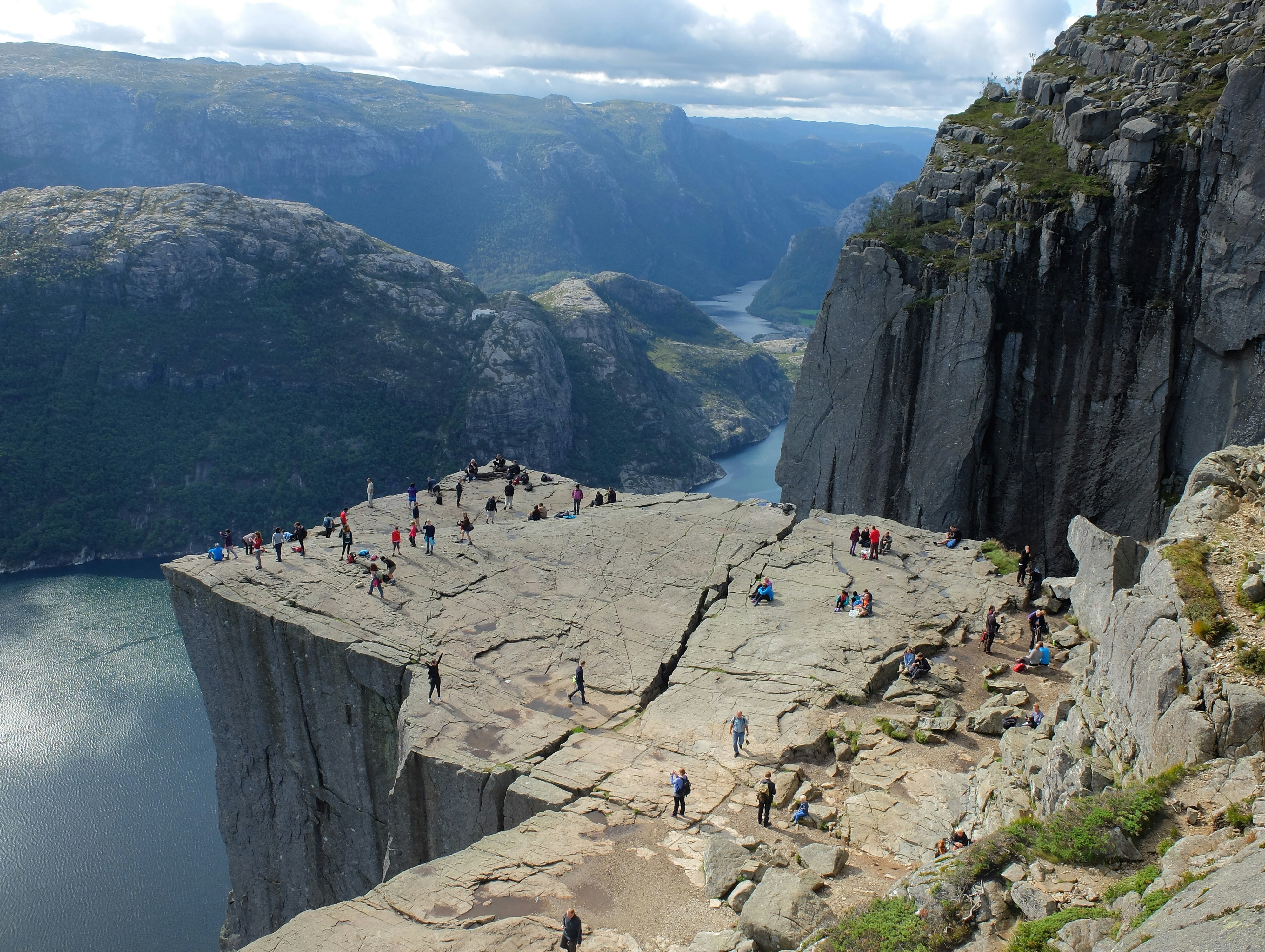 group of people on mountain cliff